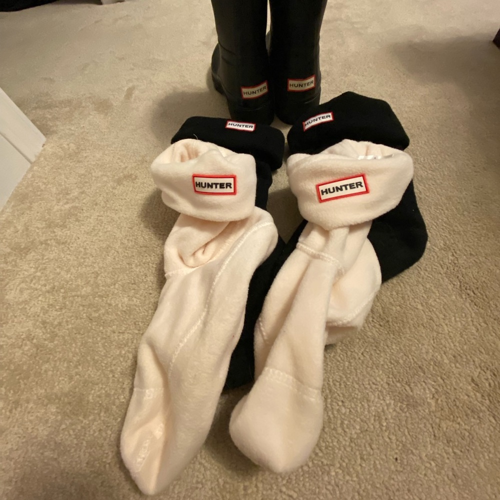 Black Hunter boots with two pairs of Hunter boot socks.